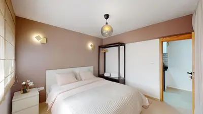 a bedroom with a white bed and a window at My Cosy Place Rabat - Studio Agdal 50m Arribat Center in Rabat