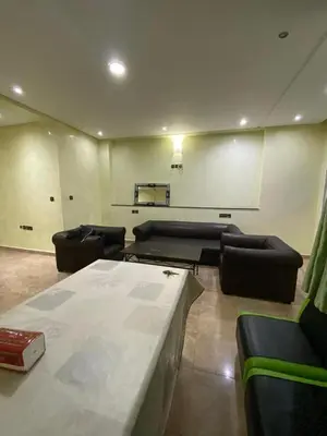 a large living room with couches and a table at Résidence Faouazi in Casablanca
