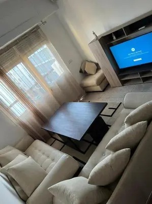 a living room with couches and a table and a television at Cozy place in the heart of rabat in Rabat