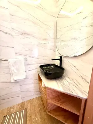 a bathroom with a sink and a mirror on a counter at Apartement sur la corniche, vue sur mer in Rabat