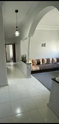 a living room with a large couch in a room at Appartement calme et confort entier à 10 mn de la corniche, une demie heur de stade d honneur in Casablanca