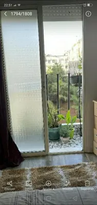 an open sliding glass door with potted plants outside at Appartement calme et confort entier à 10 mn de la corniche, une demie heur de stade d honneur in Casablanca