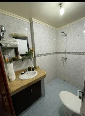 a bathroom with a sink and a shower at Appartement calme et confort entier à 10 mn de la corniche, une demie heur de stade d honneur in Casablanca
