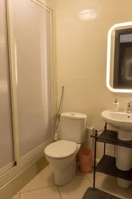 a bathroom with a toilet and a sink at Grand appartement lumineux avec balcon & parking idéal familles et pro in Casablanca