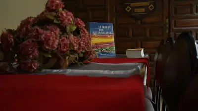 a book sitting on top of a table with flowers at Auberges Des Jeunes Casablanca in Casablanca