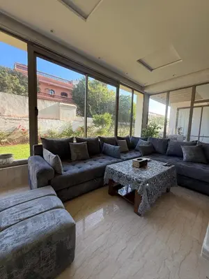a large living room with a couch and a table at Luxurious Apt with Pool&Sea View in Pont Blondin