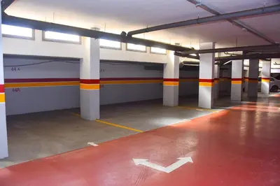 an empty parking garage with orange and white columns at Luxurious Apt with Pool&Sea View in Pont Blondin