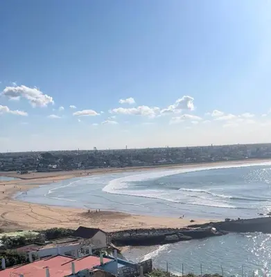 a view of a beach with people in the water at Luxurious Apt with Pool&Sea View in Pont Blondin