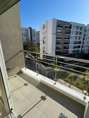 a balcony with a view of a building at Shiny appartment in Prestigia in Rabat