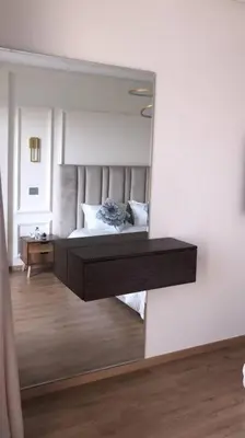 a mirror reflecting a bedroom with a bed in a room at Chez Miguel Casablanca in Casablanca