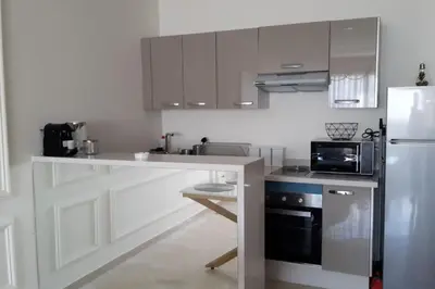 a kitchen with a counter and a microwave and a refrigerator at Chez Miguel Casablanca in Casablanca