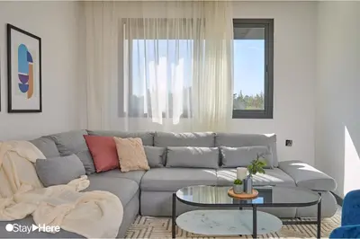 a living room with a gray couch and a table at Stayhere Rabat - Hay Riad - Sophisticated Residence in Rabat