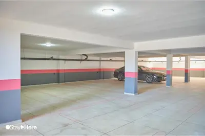 a garage with a car parked in it at Stayhere Rabat - Hay Riad - Sophisticated Residence in Rabat