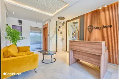 a living room with a yellow couch and a piano at Stayhere Rabat - Hay Riad - Sophisticated Residence in Rabat