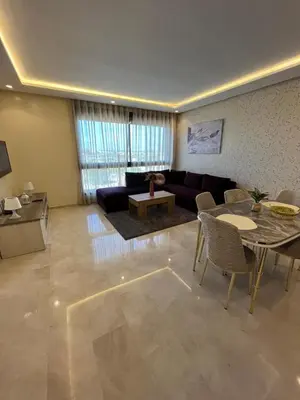 a living room with a couch and a table at Luxurious Appartement at Casa Finance City in Casablanca