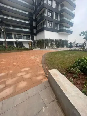a large building with a brick walkway in front of a building at Luxurious Appartement at Casa Finance City in Casablanca