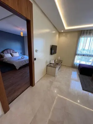 a bedroom with a bed and a large mirror at Luxurious Appartement at Casa Finance City in Casablanca