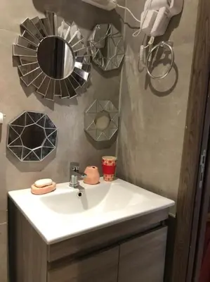 a bathroom with a white sink and a mirror at Charmant studio lumineux Casablanca in Bouskoura