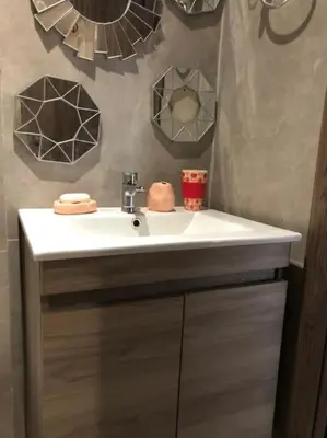a bathroom with a white sink and mirrors at Charmant studio lumineux Casablanca in Bouskoura