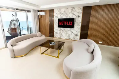a living room with two chairs and a couch and a table at Casablanca Marina Ocean View - By AppartAli in Casablanca