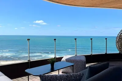 a view of the ocean from a balcony with a table at Casablanca Marina Ocean View - By AppartAli in Casablanca