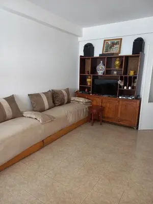 a living room with a couch and a television at STAR APPARTEMENT GAUTHIER in Casablanca