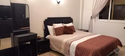 a bedroom with a bed with a dresser and a mirror at STAR APPARTEMENT GAUTHIER in Casablanca