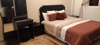a bedroom with a bed with a dresser and a mirror at STAR APPARTEMENT GAUTHIER in Casablanca
