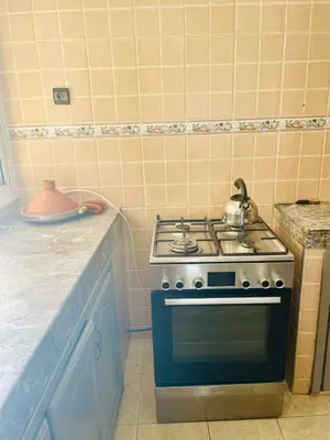 a kitchen with a stove with a tea pot on it at STAR APPARTEMENT GAUTHIER in Casablanca