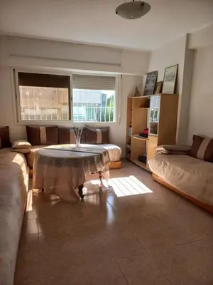 a living room with a table and a couch at STAR APPARTEMENT GAUTHIER in Casablanca