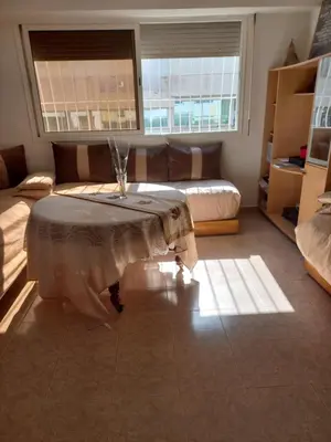 a living room with a table and a couch at STAR APPARTEMENT GAUTHIER in Casablanca