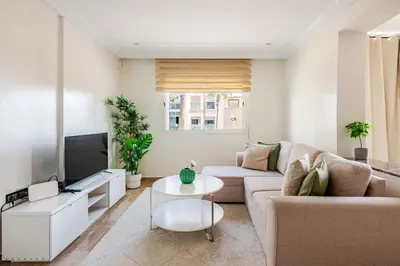 a living room with a couch and a tv at TT Holidays-Rabat City Center in Rabat