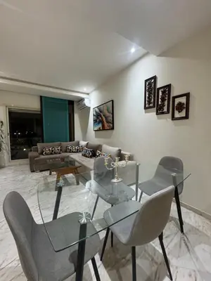 a living room with a glass table and chairs at Coup de cœur a 5mn de l aéroport in Nouaceur