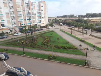 a park in the middle of a street with buildings at Coup de cœur a 5mn de l aéroport in Nouaceur