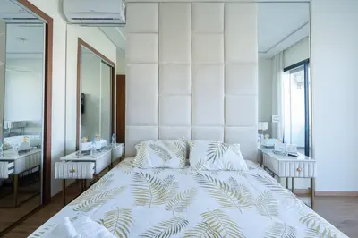 a bedroom with a large bed and two sinks at Paris-Oasis Casablanca in Casablanca