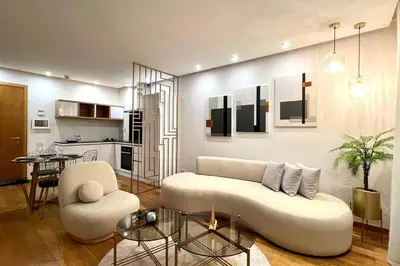 a living room with a white couch and a table at The Panorama of Marina - AppartAli in Casablanca