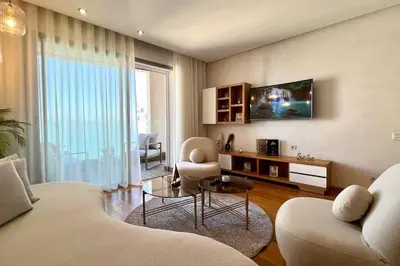 a living room with a couch and a table at The Panorama of Marina - AppartAli in Casablanca