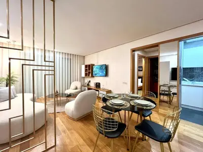 a living room with a table and chairs and a couch at The Panorama of Marina - AppartAli in Casablanca