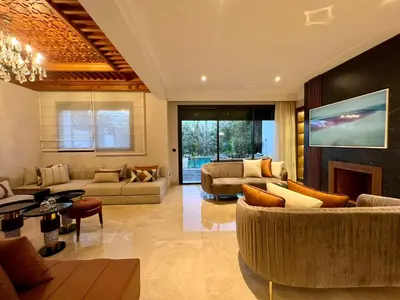 a large living room with couches and a fireplace at Golf view Villa with Jacuzzi- By AppartAli in Bouskoura