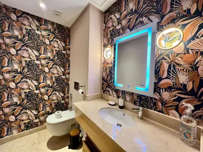 a bathroom with a sink and a tv on the wall at Golf view Villa with Jacuzzi- By AppartAli in Bouskoura