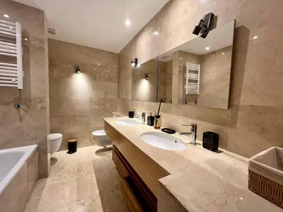 a bathroom with two sinks and a tub and a toilet at Golf view Villa with Jacuzzi- By AppartAli in Bouskoura
