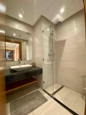 a bathroom with a glass shower and a sink at Faubourgs Anfa Top Floor By AppartAli in Casablanca
