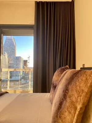 a bedroom with a window with a view of a city at Faubourgs Anfa Top Floor By AppartAli in Casablanca