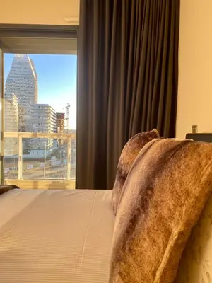 a bedroom with a bed and a large window at Faubourgs Anfa Top Floor By AppartAli in Casablanca