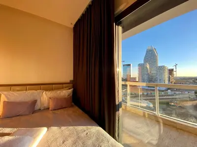 a bedroom with a bed and a large window at Faubourgs Anfa Top Floor By AppartAli in Casablanca