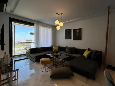 a living room with a couch and a table at Anfa 212 Top Floor - 2 Bedrooms- By AppartAli in Casablanca