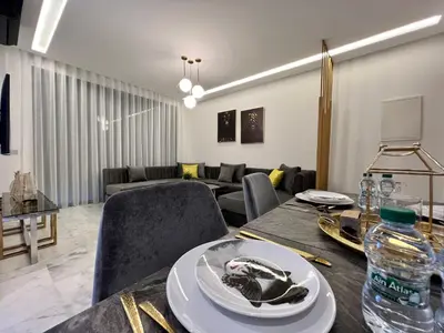 a living room with a table and a couch at Anfa 212 Top Floor - 2 Bedrooms- By AppartAli in Casablanca
