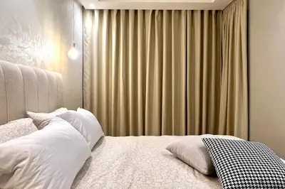 a bedroom with a bed and a window with curtains at The Suite of Artists - Central - By AppartAli in Casablanca