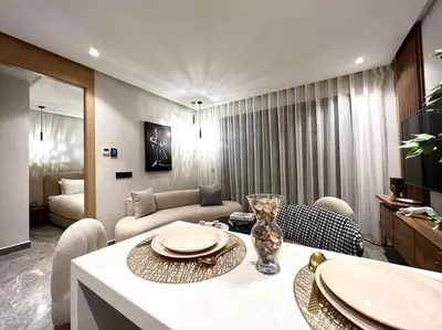 a living room with a table and a couch at Presidential Suite City Center by AppartAli in Casablanca