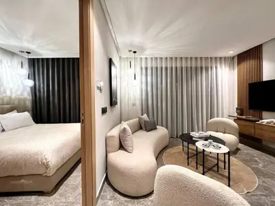 a hotel room with a bed and a living room at Presidential Suite City Center by AppartAli in Casablanca